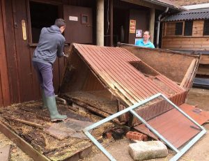 Volunteers dismantle the old goose hut