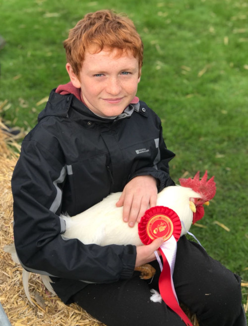 Young farmer and winning hen