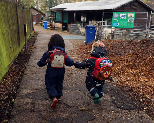 Two children heading to see the goats 